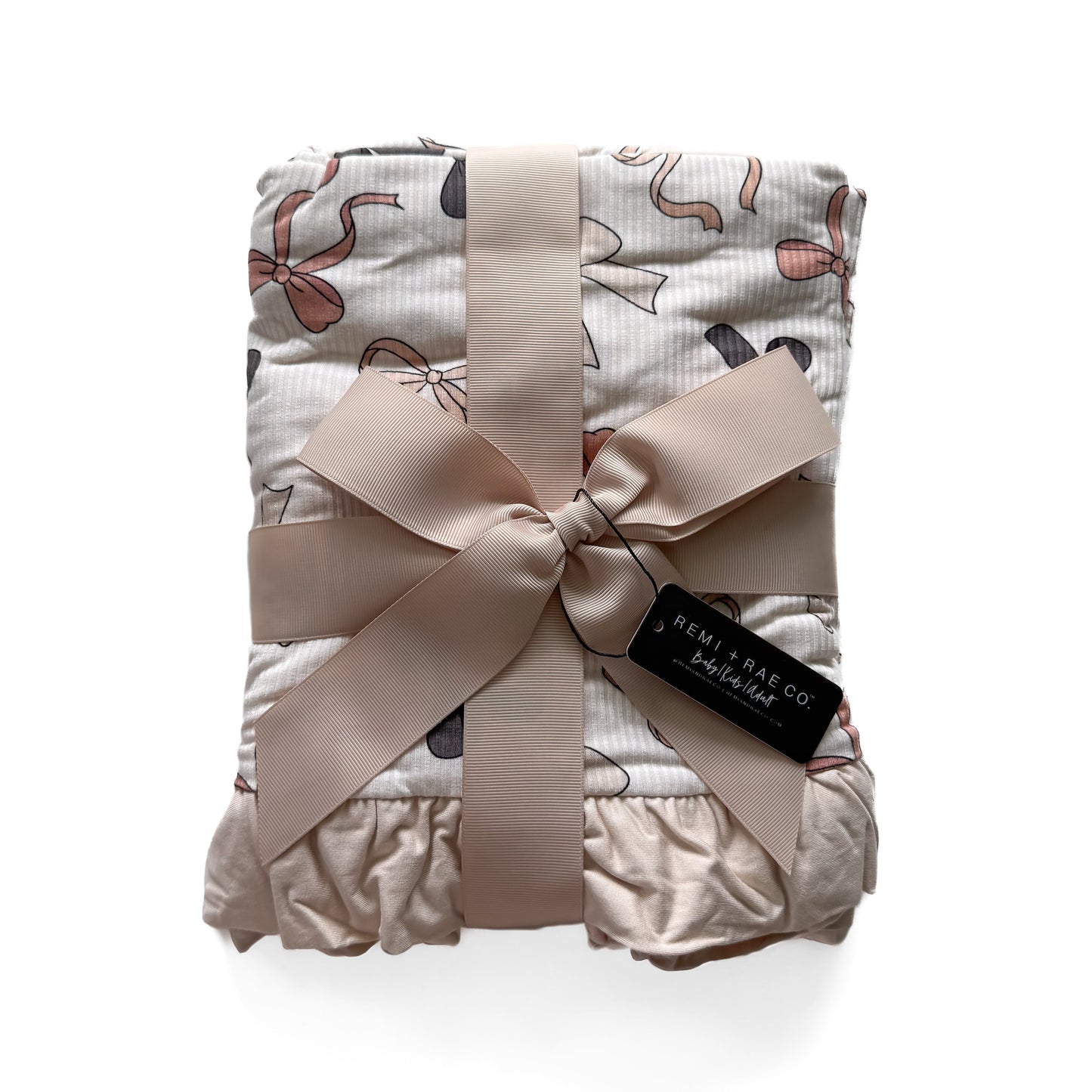 Folded baby blanket with a bow and brand tag on a white background