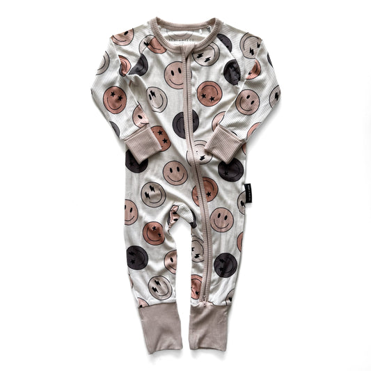 Baby onesie with smiley face pattern on a white background
