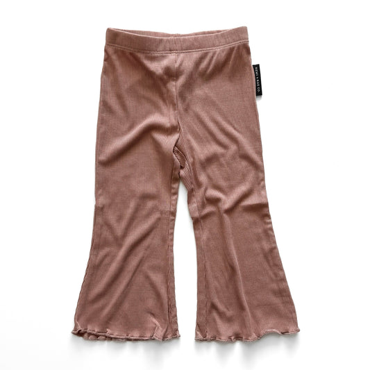 rose flared pants on a white background